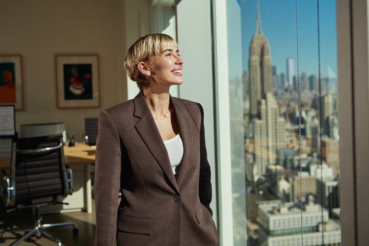 A confident professional looking out over a city skyline, ready to build a career abroad